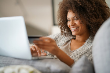 Wall Mural - Beautiful mixed-race woman shopping on internet