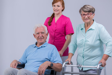 Canvas Print - Disabled senior couple and carer