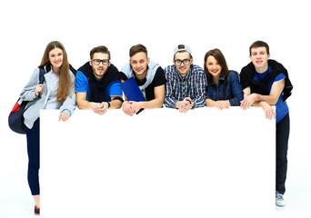 Wall Mural - Full length portrait of confident college students displaying blank billboard against white background