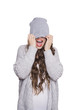 Modern teenage girl in  beanie hat and gray sweater. Fashionable young woman posing. Studio portrait isolated white background. Screaming model.