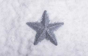 Wall Mural - silver star placed in snow