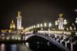 Pont Alexandre III Bridge illuminated at night in Paris, France