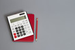calculator and red pencil on desk