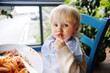 © Maria Sbytova - Cute toddler boy eating pasta in Italian indoors restaurant