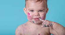 Amusing Smile Of A Cute Babygilr Covered In Paint