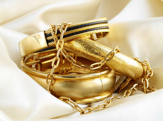 Gold jewelry, bracelets and chains. Luxury accessories.