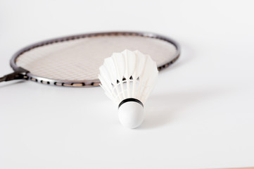 the white Badminton shuttlecock and racket on white background