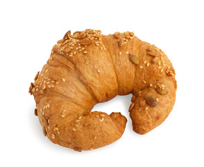 Croissant with sesame, pumpkin seeds isolated on a white background