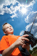 © tcsaba - Little boy repaire the radio control car outdoor near field