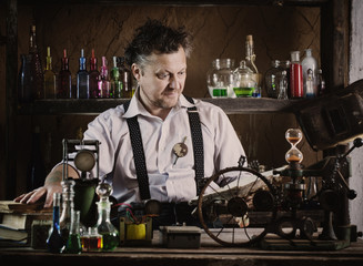 Wall Mural - crazy medieval scientist reading book in his laboratory