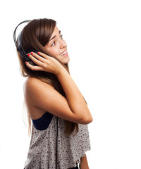 Wall Mural - young woman listening to music with headphones isolated on white