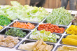 Various vegetables mixed on salad bar.