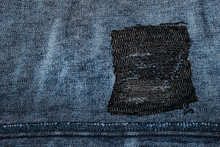 Blue Denim With A Patch. Fabric Grunge Texture In High Resolution