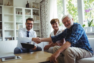 Financial advisor shaking hands with senior man