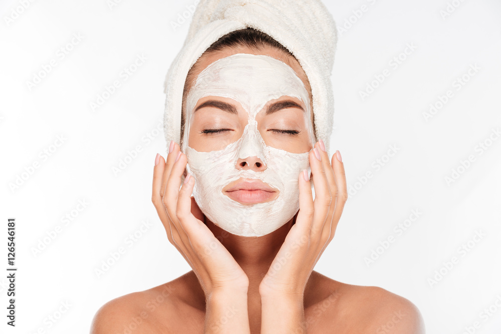 Woman with eyes closed and white facial mask on face - obrazy, fototapety, plakaty 