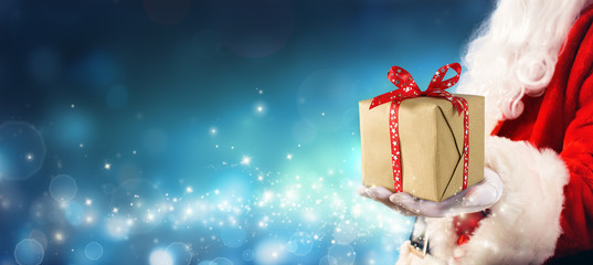 Christmas Gift - Santa Claus Giving Gift Box In Magic Night
