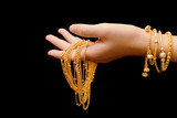 Fototapeta Do akwarium - woman's hand with many different gold jewelry on black backgroun