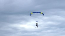 Man Landing His Parachute On The Beach