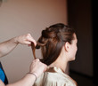 © timonko - hairdresser makes the bride hairstyle in wedding morning