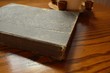 Closed old book with yellowed pages on wooden countertop