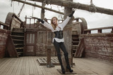Sexy woman in pirate style with old handgun