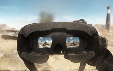 First person view soldier hand in black battle gloves & tactical jacket using vr glasses on desert tank war scene with health & armor indicator.