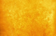 Bubbles floating in the liquid orange drink, abstract image.