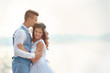 © Africa Studio - Beautiful wedding couple on light blurred background, close up view
