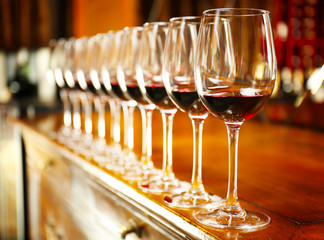 Wall Mural - Row of glasses with red wine on bar counter