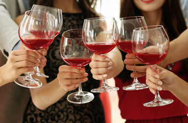 Wall Mural - People toasting with glasses of red wine, closeup