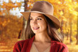 © Africa Studio - Portrait of beautiful young woman wearing hat in autumn park, close up
