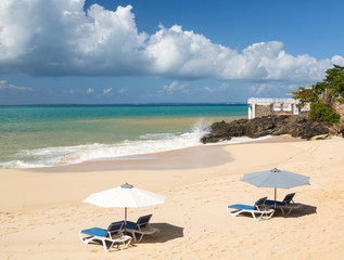 Reclining chairs and umbrella on Baie Rouge