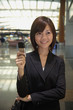 © Alexander - Young woman with mobile phone at the airport