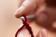 © Syda Productions - close up of hands knitting with crochet hook