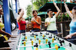 Young women celebrating winning a game of foosball