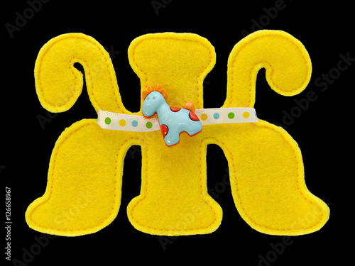 Fotografie, Obraz Letter of the alphabet made of yellow felt isolated on black background