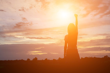 Wall Mural - Silhouette of woman praying over beautiful sky background