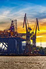 Wall Mural - Oil rig under construction at sunset in Gdansk, Poland.