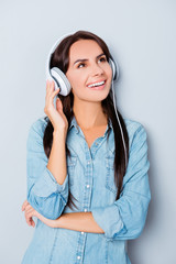 Wall Mural - Cheerful happy woman listening favorite song in headphones