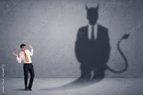 Foto Business man looking at his own devil demon shadow concept