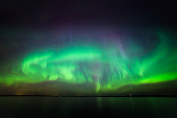 Wall Mural - Northern lights over lake in finland