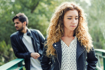 Young couple being in a conflict in the park.