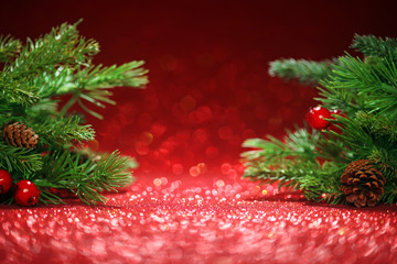 Wall Mural - Christmas tree branches on glittering red background