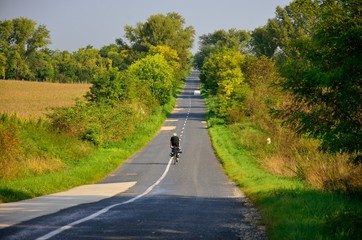 Wall Mural - Boy ride on bicycle in autumn misty morning. Original sport wallaper