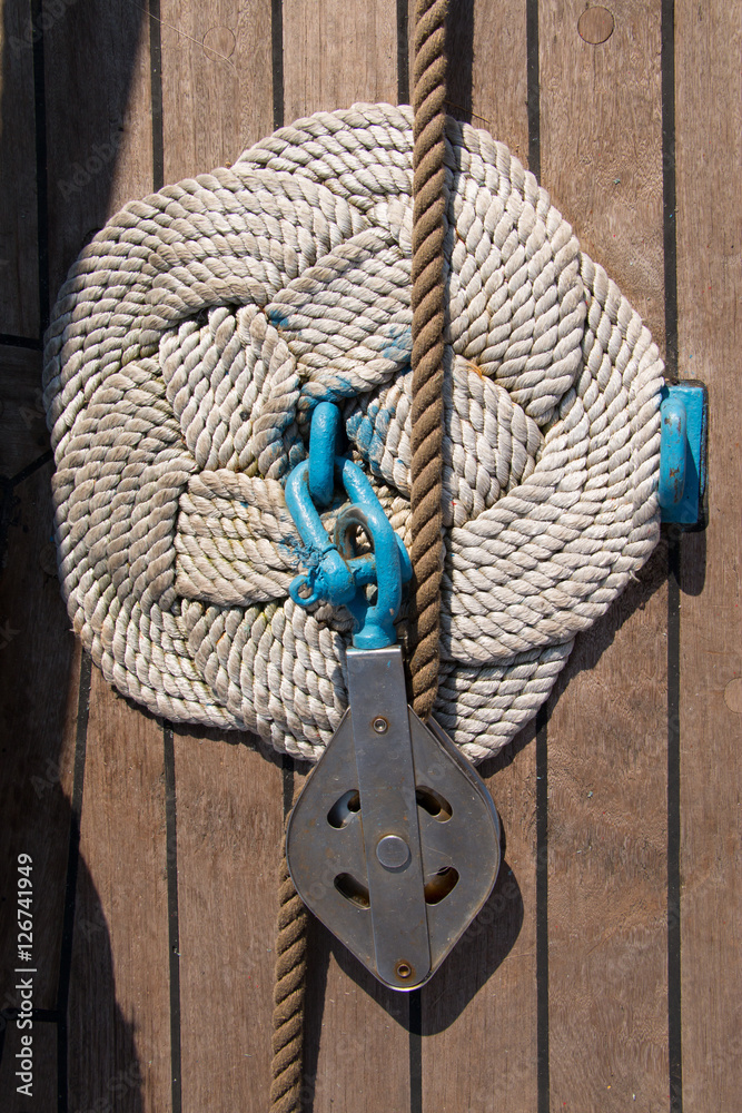 Deck and ropes, rigging on a wooden tall ship sail yacht. Close up view ...