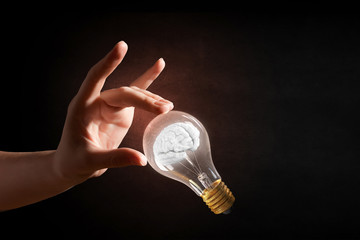 Wall Mural - hand pointing light bulb . mixed media