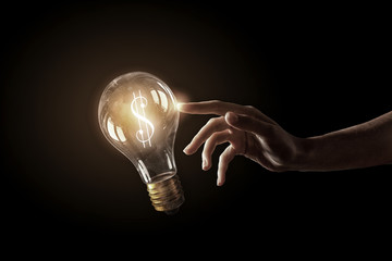 Wall Mural - hand pointing light bulb . mixed media