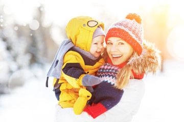 Poster - happy family mother and baby is happy snow on winter walk