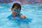 Fototapeta Przestrzenne - Asia Child having fun in swimming pool. Kid playing outdoors.