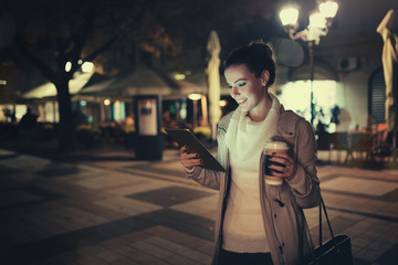 Girl using tablet at night